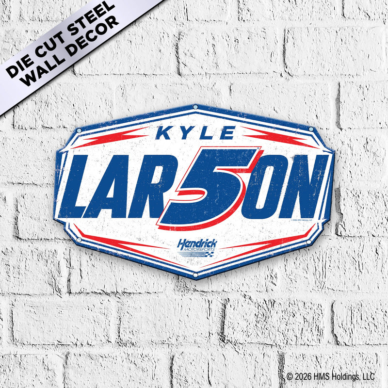 Kyle LAR5ON Hendrick Motorsports die-cut octagonal steel badge sign mounted on white brick wall — vintage racing design with bold blue LAR5ON lettering and red #5 integrated into name