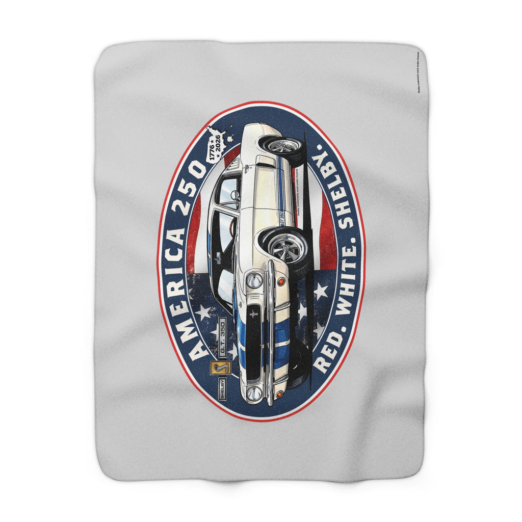 A light gray fleece blanket featuring a large graphic print of a classic car inside a circular emblem with the text 'AMERICA 250', 'SHERIFF', and 'RED, WHITE, AND BLUE'.